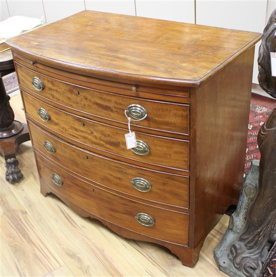 A George III mahogany bowfront chest with brushing slide, W.94cm D.58cm H.82cm